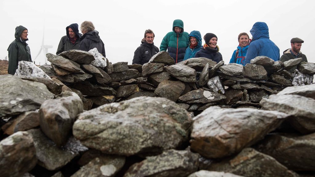 People standing above some rocks